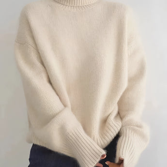 Women's grey oversized cashmere turtleneck sweater with long sleeves, showcasing a cozy and warm design, perfect for outerwear.