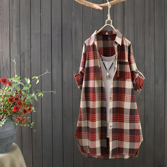 Women's Cozy Plaid Linen Dress in autumn vintage style, hanging on a wooden clothes hanger, featuring a tartan pattern with long sleeves and a midi length.