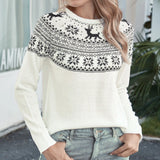 Women's cozy winter sweater in white featuring reindeer and snowflake knit patterns, shown in an XL size. The sweater includes long sleeves and a round neckline, highlighting a mix of black and white textile design.