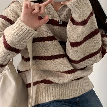Women's cream and burgundy striped sweater featuring puff sleeves, showcased on a model with focus on the neckline, sleeves, and waist area. The model's pose highlights the sweater's design and fit.