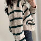 Women's cream and burgundy striped puff sleeve sweater, featuring a comfortable knit design perfect for autumn, showcased on a model.