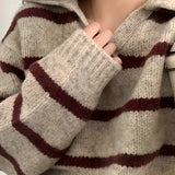 Women's cream and burgundy striped puff sleeve sweater worn, showcasing the unique design and knit texture at the neck and sleeves.