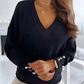 
A woman wearing a black women's deep V-neck button cuff sweater in size XXL. The sweater is styled for both office and casual settings.
