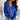 Woman wearing a deep V-neck white sweater with button cuffs, showcasing its cozy and versatile design suitable for office and casual settings. The sweater features long sleeves and a comfortable knit fabric.