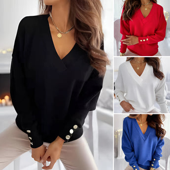 Women's deep V-neck sweater with button cuffs, featuring a cozy knit texture in a two-tone black and white design, highlighting the shoulders and waist with long sleeves and a comfortable fit.