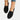 Women's black denim flats with chain ankle bracelet, shown on foot, size 42.