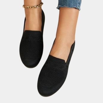 Women's black denim flats with chain ankle bracelet, shown on foot, size 42.