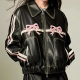 Women's designer leather jacket featuring a distinctive bow motif and metallic stripes, showcasing a fitted design with a structured collar, long sleeves, and tailored waist, perfect for a stylish outerwear look.