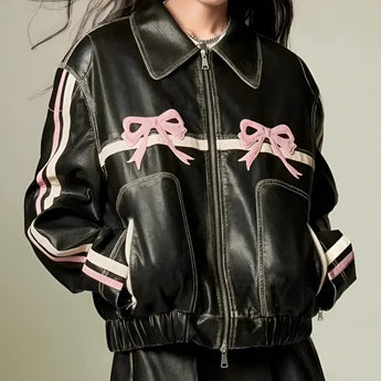 Women's designer leather jacket featuring a distinctive bow motif and metallic stripes, showcasing a fitted design with a structured collar, long sleeves, and tailored waist, perfect for a stylish outerwear look.