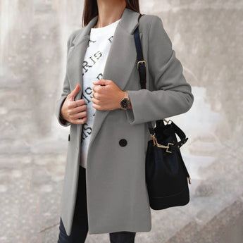 Women's double-breasted long gray winter coat with chic urban style, featuring a fashionable overcoat design with structured shoulders, long sleeves, and a tailored waist.