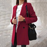 Women's burgundy double-breasted long winter coat with a chic urban style, featuring a trench coat design, wide collar, and long sleeves, suitable for colder weather.