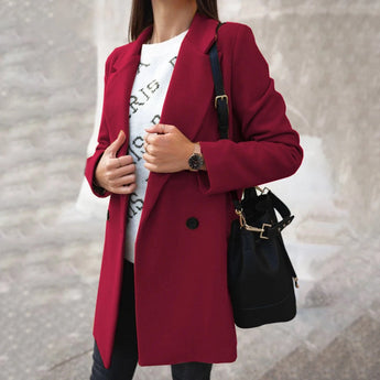 Women's burgundy double-breasted long winter coat with a chic urban style, featuring a trench coat design, wide collar, and long sleeves, suitable for colder weather.