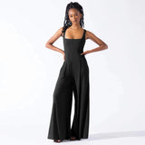 
A woman wearing an elegant black formal wide-leg sleeveless jumpsuit in size 2XL.