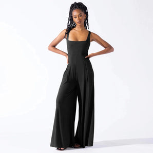 
A woman wearing an elegant black formal wide-leg sleeveless jumpsuit in size 2XL.