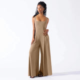 
A woman wearing an elegant black formal wide-leg sleeveless jumpsuit.