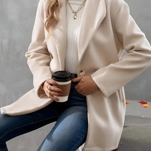Elegant cream wool oversized winter coat for women, showcasing fall fashion style. The coat features a refined design with a soft shoulder line and a structured neck. The model is wearing sunglasses and a white dress shirt underneath, perfectly complementing the fashionable outerwear.