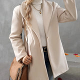 Elegant cream wool oversized winter coat worn by a woman, showcasing fall fashion style. The coat complements denim jeans and shoes, accessorized with sunglasses, highlighting a chic and modern look.