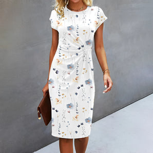 Elegant white floral knee-length sheath dress for women, featuring short sleeves and a fitted silhouette, suitable for both office and casual settings.