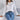 
A stylish women's elegant white V-neck knit sweater featuring distinctive lantern sleeves, displayed in an XL size.