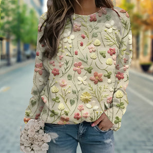Women's sweater featuring 3D flower applique embroidery, showcasing intricate floral designs on a white outerwear piece with green accents, displaying shoulder and neckline details for a fashionable look.