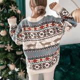 
A women's cozy blue and white knit Fair Isle Christmas sweater featuring intricate patterns on the textile, with long sleeves and a round neck design suitable for the holiday season.