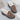Women's brown faux fur-lined suede loafers featuring a bow tie design, showcasing their natural material and pattern.