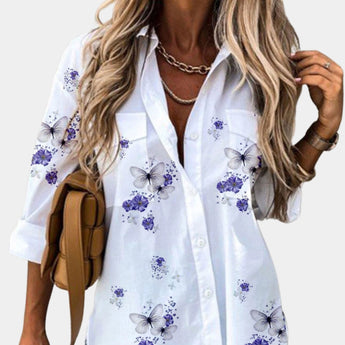 Women's floral blouse with 3/4 sleeves in elegant white and purple design, featuring a V-neckline, displayed in size 2XL.