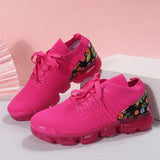 Women's floral mesh sneakers featuring a pink sole, designed for lightweight and breathable comfort, shown in shades of purple, grey, and pink with a sporty, walking shoe style.