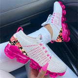 Women's lightweight and breathable floral mesh sneakers with a pink sole, featuring a white and pink color scheme, displayed with a focus on the textile material.