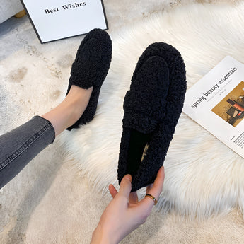 Women's fluffy slippers with plush material, shown being worn to highlight their cozy and warm comfort, ideal for non-slip use on various flooring types during winter.