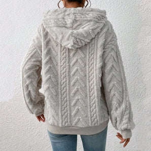 Women's grey fur-lined cable-knit hoodie featuring long sleeves and a cozy collar, designed for winter wear.