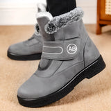 Women's gray fur-lined suede snow boots, featuring an anti-skid sole designed for winter conditions.