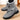 Women's gray fur-lined suede snow boots, featuring an anti-skid sole designed for winter conditions.