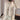 Women's beige fuzzy shearling zip-up vest in 6XL, featuring a soft texture and cozy design perfect for winter fashion. The vest includes a collar and is styled over a white dress shirt.