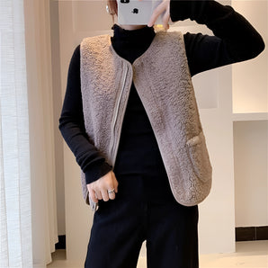 Women's white fuzzy shearling zip-up vest with grey accents, featuring a high collar and tailored waist design, ideal for cozy winter fashion.