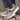 Women's gray fleece-lined winter loafers on feet, shown outdoors on grass, showcasing their stylish slip-on design and warm lining, ideal for cold weather.
