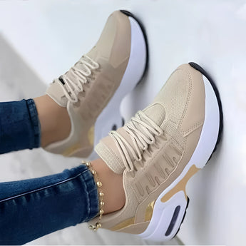 Women's beige lightweight breathable mesh sneakers with ankle support, shown worn with jeans, suitable for outdoor activities.