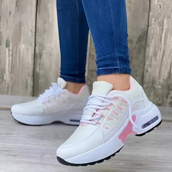 Women's gray lightweight breathable mesh sneakers with ankle support, featuring white and pink accents. The shoes are designed for walking and sportswear, shown against a floor background.