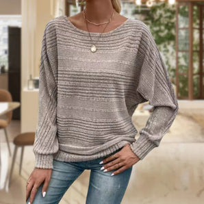 Women's gray striped oversized knit pullover sweater with casual dolman sleeves, shown in size 3XL, paired with jeans.
