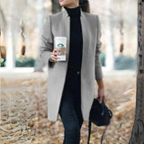 Women's gray wool coat in a slim fit design with a turtleneck collar, featuring long sleeves and a chic, cozy style suitable for fashion-forward outerwear.