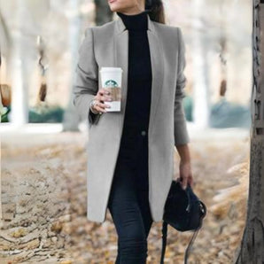 Women's gray wool coat in a slim fit design with a turtleneck collar, featuring long sleeves and a chic, cozy style suitable for fashion-forward outerwear.