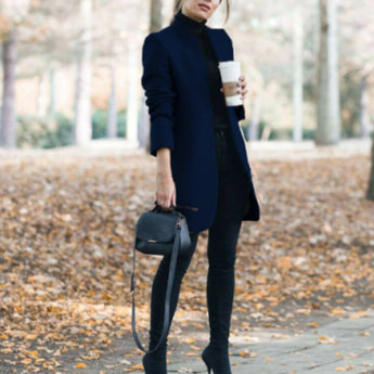 
A women's dark blue slim fit wool coat featuring a turtleneck design. The coat is styled with long sleeves and extends to knee length, showcasing a chic and cozy fashion statement suitable for colder weather.