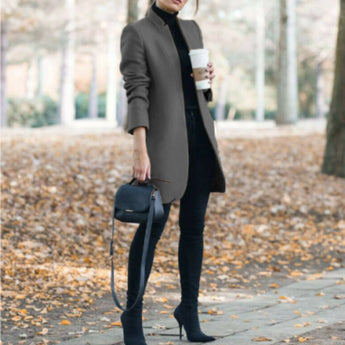 Women's dark gray wool coat with a slim fit design featuring a turtleneck collar, long sleeves, and knee-length coverage, styled for a cozy and chic fashion look.