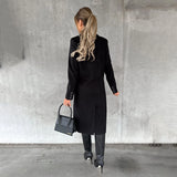 A stylish gray wool knee-length coat for women, featuring long sleeves and a tailored waist, designed for urban fashion.