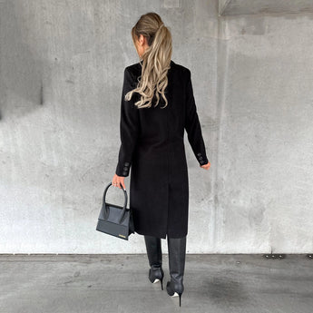 A stylish gray wool knee-length coat for women, featuring long sleeves and a tailored waist, designed for urban fashion.