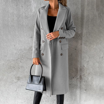 Women's gray wool knee-length coat in an urban fashion style, featuring a structured design with long sleeves and a classic collar, suitable for a sophisticated and modern look. The coat is worn by a standing model, showcasing its fit and elegance in a 3XL size.