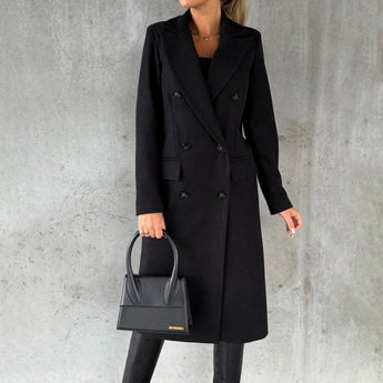 A women's gray wool knee-length coat with long sleeves and structured shoulders, designed for urban fashion, displayed in a size 3XL.