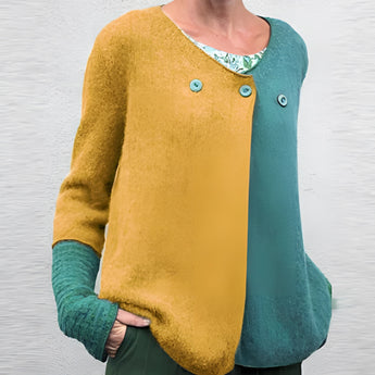 Women's green and blue two-tone color block knit sweater featuring long sleeves and a round collar.