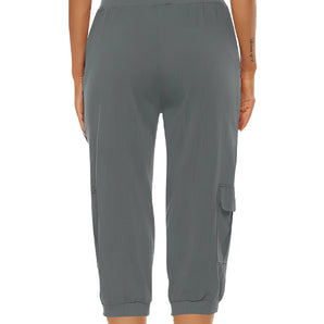 Women's green cargo capri pants featuring an elastic waist, shown on a model.