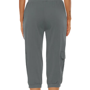 Women's green cargo capri pants featuring an elastic waist, shown on a model.